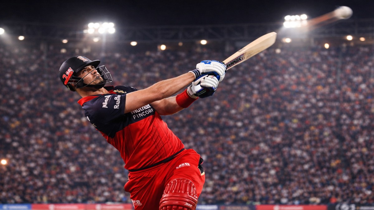 Tim David hitting a powerful six for Royal Challengers Bengaluru in IPL under stadium lights